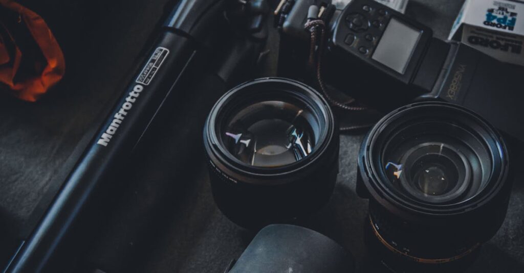 Close-up of a photography setup featuring camera lenses, tripod, and film rolls for professional use.